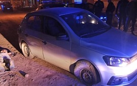 Uno de los cuatro detenidos, junto al veh&iacute;culo robado que protagoniz&oacute; la persecuci&oacute;n.